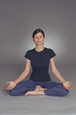A serene scene of people meditating in a peaceful environment with soft lighting and calm surroundings