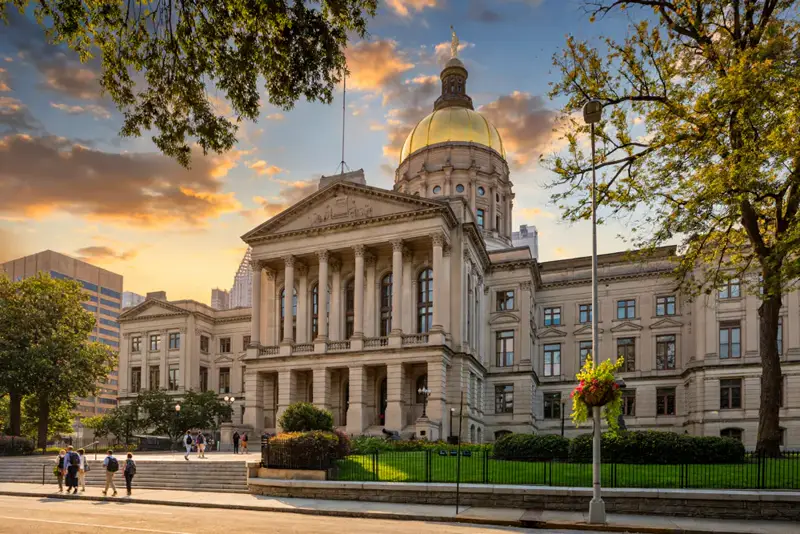 Georgia State Capitol in Atlanta with its iconic gold dome at sunset